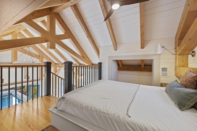 bedroom featuring visible vents, wood walls, and vaulted ceiling with beams