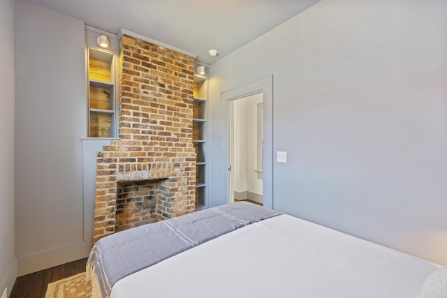 bedroom featuring wood finished floors and baseboards