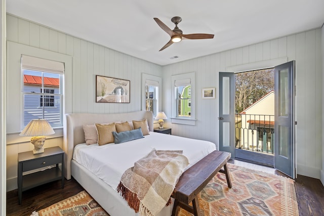 bedroom with visible vents, wood finished floors, a ceiling fan, and access to outside