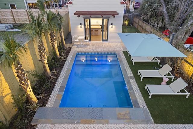 view of swimming pool featuring a fenced backyard and a fenced in pool