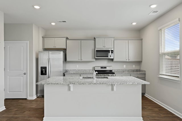 183 Greenwich Dr, Summerville, SC 29486 - kitchen featuring an island with sink, baseboards, dark wood finished floors, and stainless steel appliances
