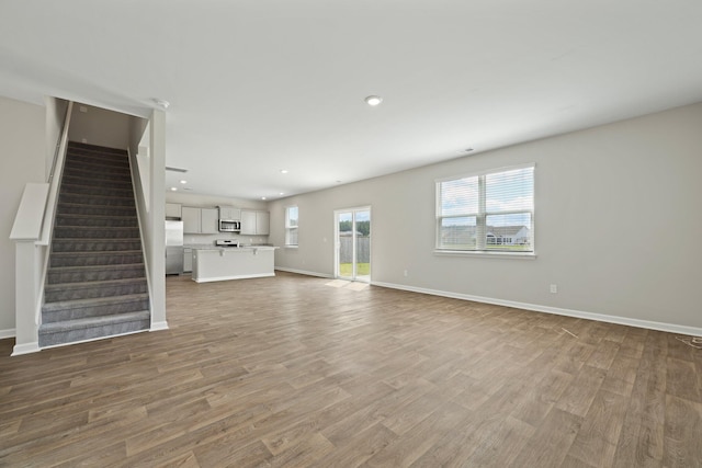 183 Greenwich Dr, Summerville, SC 29486 - unfurnished living room with recessed lighting, stairway, light wood-style floors, and baseboards