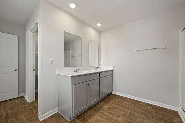 183 Greenwich Dr, Summerville, SC 29486 - bathroom featuring a sink, baseboards, double vanity, and wood finished floors