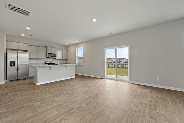 183 Greenwich Dr, Summerville, SC 29486 - kitchen with baseboards, recessed lighting, an island with sink, visible vents, and appliances with stainless steel finishes