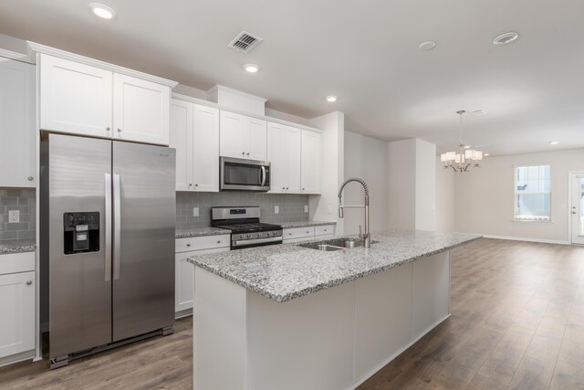 304 Pathfinder Way, Charleston, SC 29492 - kitchen featuring appliances with stainless steel finishes, a sink, a chandelier, tasteful backsplash, and white cabinets