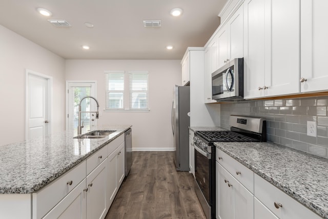 304 Pathfinder Way, Charleston, SC 29492 - kitchen with appliances with stainless steel finishes, a sink, dark wood-style flooring, white cabinetry, and an island with sink