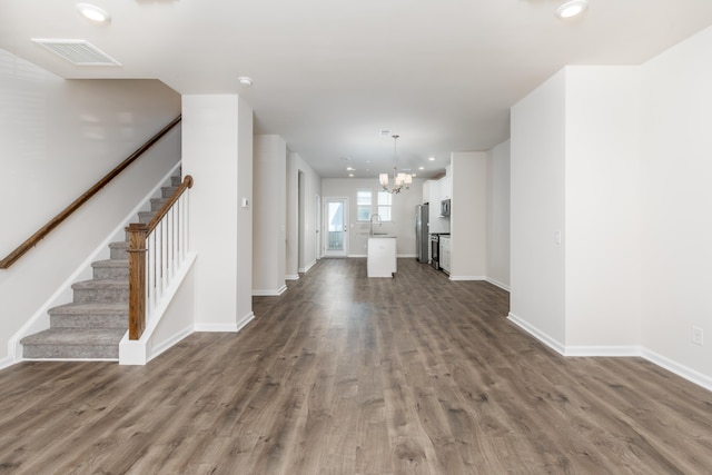 304 Pathfinder Way, Charleston, SC 29492 - unfurnished living room featuring a chandelier, dark wood finished floors, stairs, baseboards, and recessed lighting