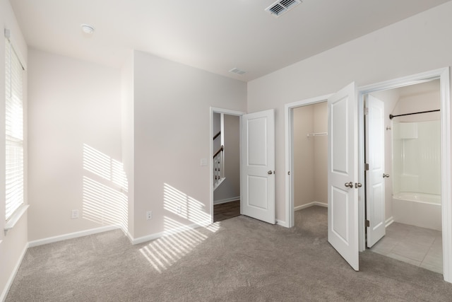 304 Pathfinder Way, Charleston, SC 29492 - unfurnished bedroom with carpet floors, a walk in closet, a closet, ensuite bathroom, and baseboards