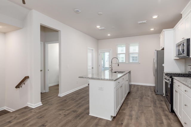 304 Pathfinder Way, Charleston, SC 29492 - kitchen with stainless steel appliances, a sink, a center island with sink, white cabinetry, and dark wood-style floors