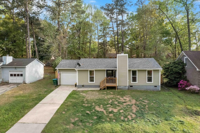 view of front facade with crawl space, a chimney, an attached garage, a front lawn, and driveway