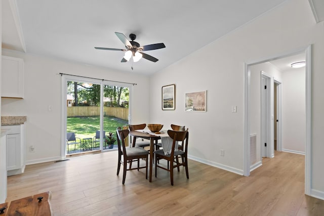 dining room featuring light wood-style flooring, ceiling fan, and baseboards