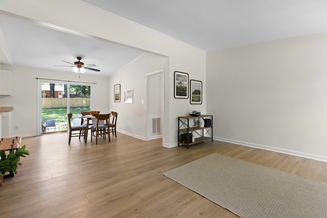 dining space with a ceiling fan, light wood-type flooring, and baseboards