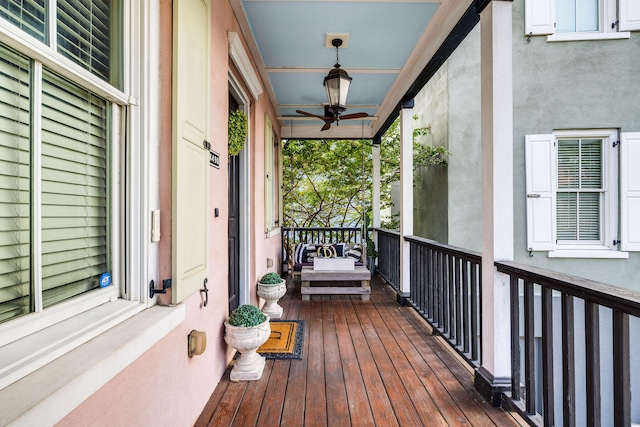 wooden deck featuring ceiling fan and a porch