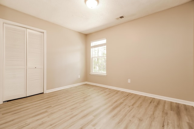 258 Trickle Dr, Summerville, SC 29483 - unfurnished bedroom with wood finished floors, baseboards, and a closet