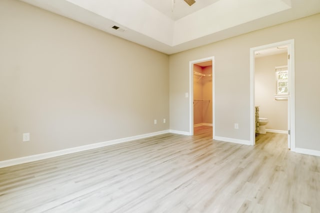 258 Trickle Dr, Summerville, SC 29483 - unfurnished bedroom featuring light wood-type flooring, a spacious closet, a closet, baseboards, and connected bathroom