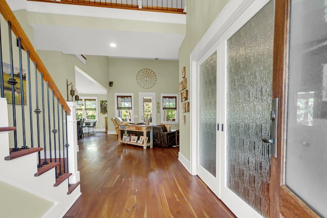 foyer entrance with dark hardwood / wood-style flooring, french doors, and a high ceiling