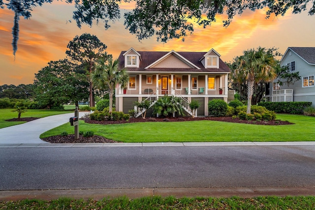 view of front of home with a lawn and covered porch