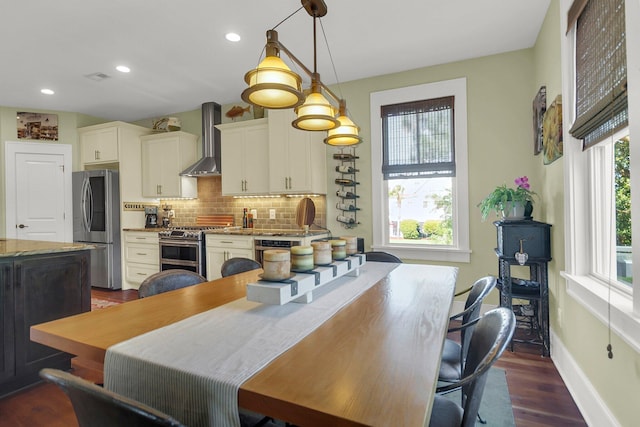 dining space featuring dark hardwood / wood-style flooring