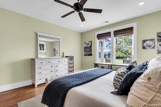 bedroom with hardwood / wood-style floors and ceiling fan