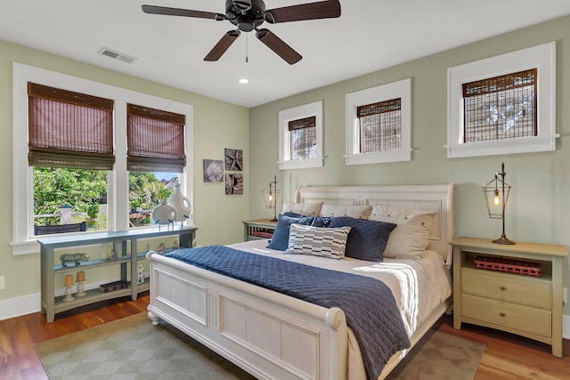 bedroom with hardwood / wood-style floors and ceiling fan