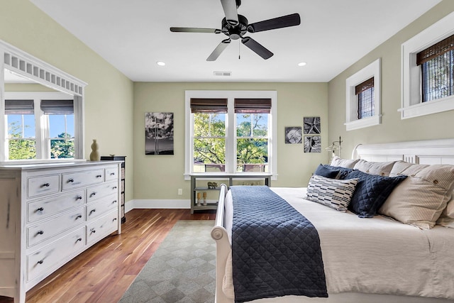 bedroom with hardwood / wood-style floors and ceiling fan