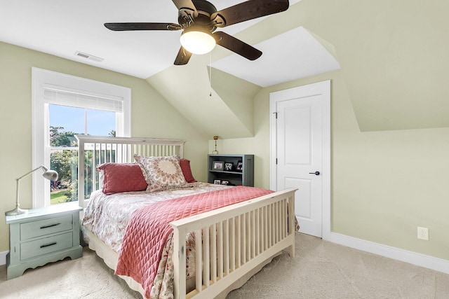 carpeted bedroom featuring ceiling fan and vaulted ceiling