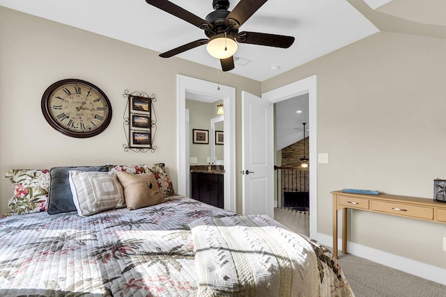 bedroom with ensuite bathroom, ceiling fan, and light colored carpet