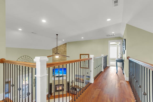 hallway with vaulted ceiling and hardwood / wood-style flooring