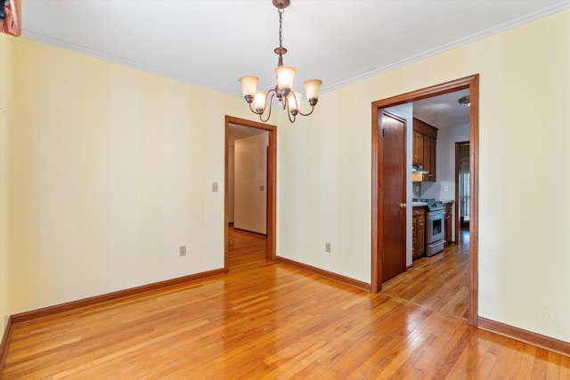 empty room featuring baseboards, an inviting chandelier, ornamental molding, and light wood finished floors