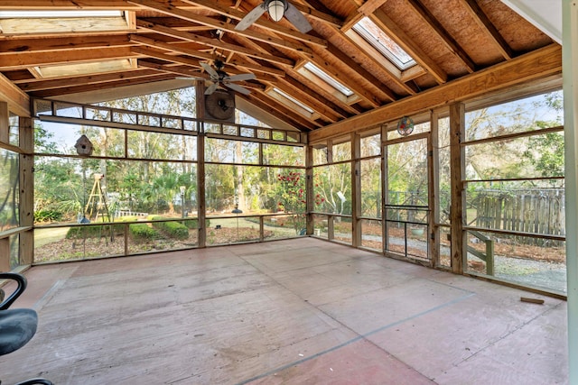 unfurnished sunroom with lofted ceiling with skylight and a ceiling fan