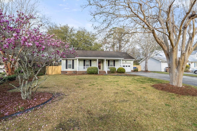 ranch-style house featuring a porch, a front yard, driveway, crawl space, and an attached garage