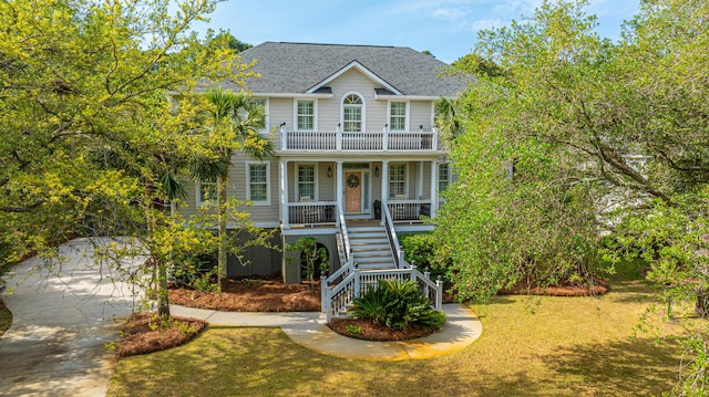 1143 Sea Eagle Watch, Charleston, SC 29412 - raised beach house with covered porch, stairs, a shingled roof, driveway, and a front lawn