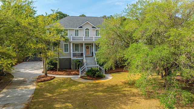 1143 Sea Eagle Watch, Charleston, SC 29412 - view of front of home with stairway, covered porch, concrete driveway, and a front lawn