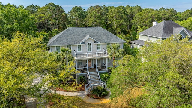 1143 Sea Eagle Watch, Charleston, SC 29412 - back of house with a view of trees, a porch, roof with shingles, stairs, and a chimney