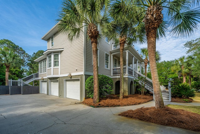 1143 Sea Eagle Watch, Charleston, SC 29412 - view of side of property with stairs, a garage, covered porch, and driveway