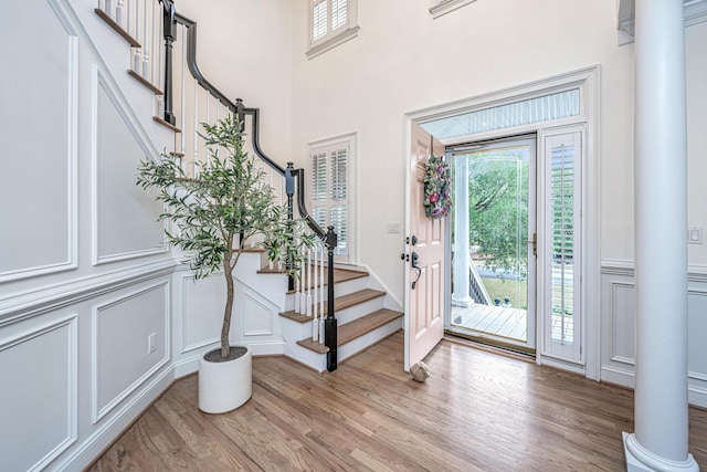 1143 Sea Eagle Watch, Charleston, SC 29412 - entrance foyer featuring a decorative wall, plenty of natural light, light wood-style floors, ornate columns, and stairway