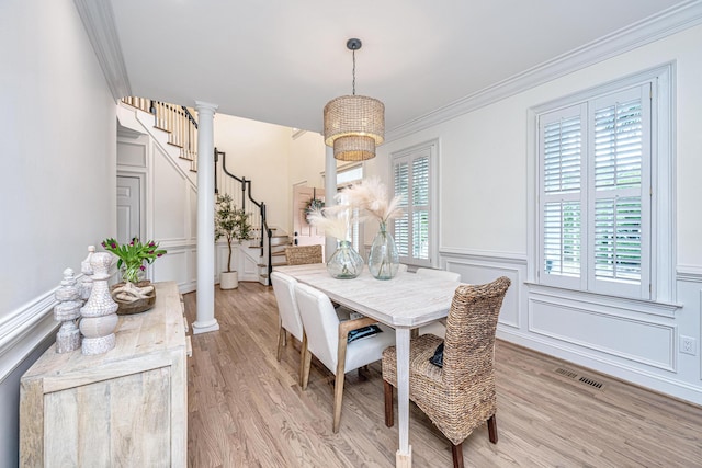 1143 Sea Eagle Watch, Charleston, SC 29412 - dining room featuring stairway, light wood-type flooring, ornamental molding, a chandelier, and wainscoting