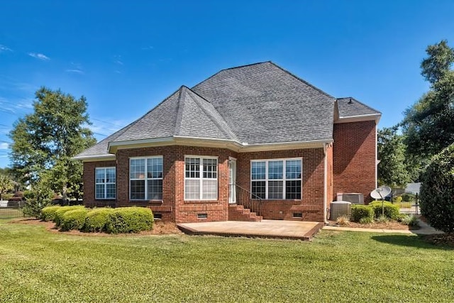 rear view of house featuring a patio, a yard, and central AC unit