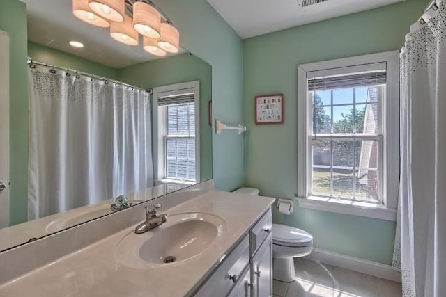 bathroom featuring toilet, tile patterned flooring, and vanity