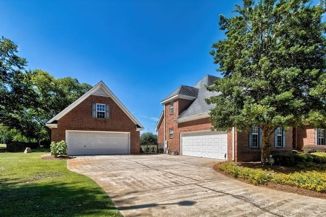 view of front of house with a garage and a front lawn