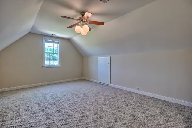 additional living space featuring light carpet, ceiling fan, and vaulted ceiling