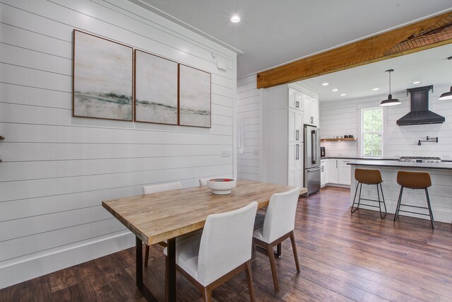 105 Bobcat Ln, Ravenel, SC 29470 - dining space featuring dark wood-style floors, wood walls, and recessed lighting