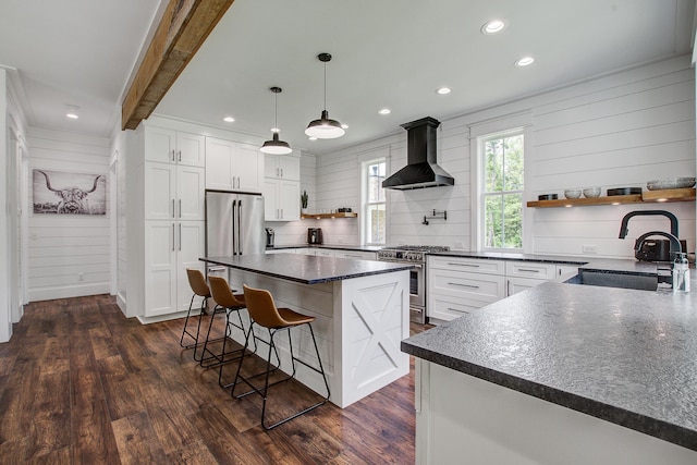 105 Bobcat Ln, Ravenel, SC 29470 - kitchen featuring wall chimney exhaust hood, stainless steel appliances, open shelves, a sink, and a kitchen breakfast bar