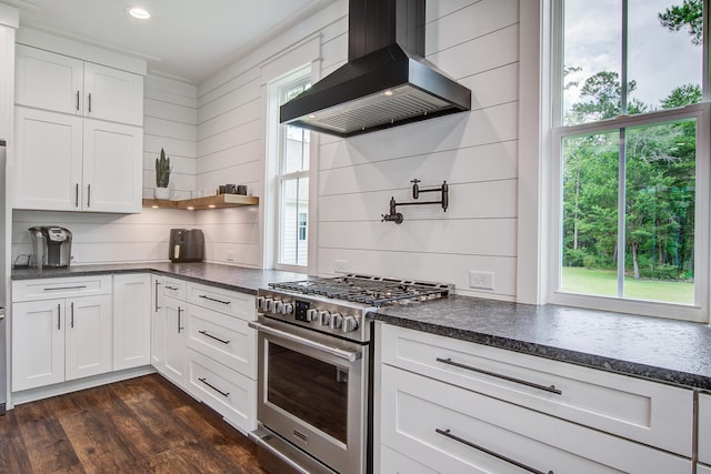 105 Bobcat Ln, Ravenel, SC 29470 - kitchen featuring wall chimney exhaust hood, stainless steel gas range oven, white cabinetry, dark wood finished floors, and recessed lighting