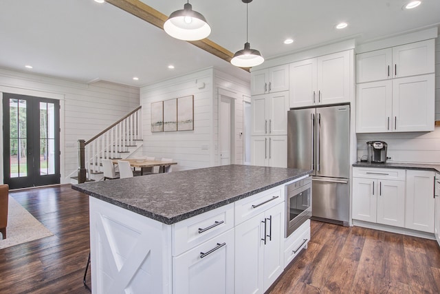 105 Bobcat Ln, Ravenel, SC 29470 - kitchen featuring appliances with stainless steel finishes, dark countertops, dark wood-style flooring, white cabinets, and crown molding
