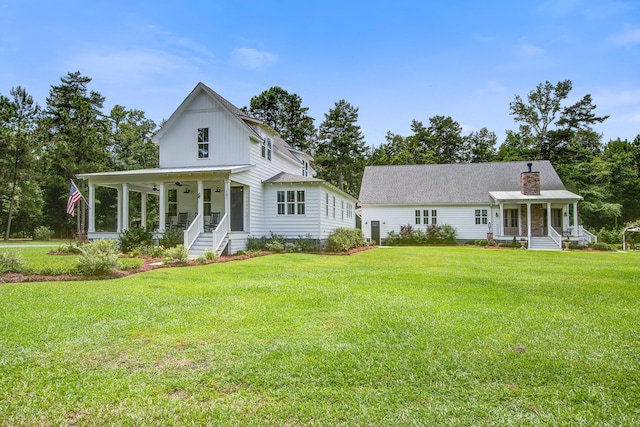 105 Bobcat Ln, Ravenel, SC 29470 - modern farmhouse with covered porch, a front lawn, and a chimney