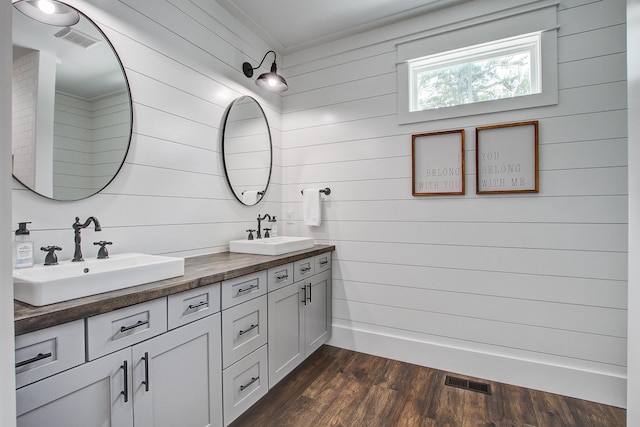 105 Bobcat Ln, Ravenel, SC 29470 - bathroom with double vanity, wood walls, and wood finished floors