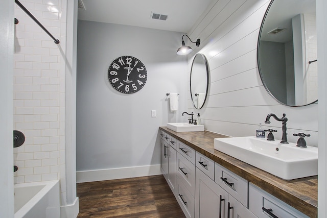 105 Bobcat Ln, Ravenel, SC 29470 - bathroom with double vanity, wood finished floors, shower / tub combination, and baseboards