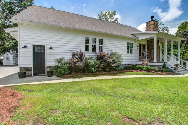 105 Bobcat Ln, Ravenel, SC 29470 - view of front of property featuring a chimney, a front lawn, a porch, and a shingled roof