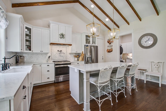 105 Bobcat Ln, Ravenel, SC 29470 - kitchen with appliances with stainless steel finishes, beamed ceiling, glass insert cabinets, white cabinetry, and tasteful backsplash